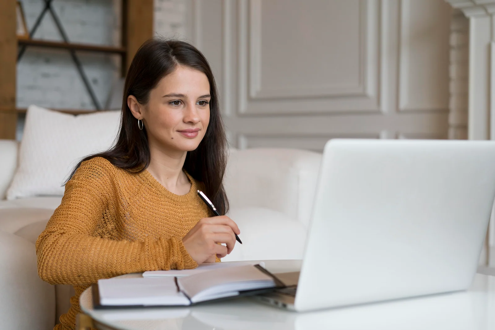 Student at a laptop at home filling out an online community college application