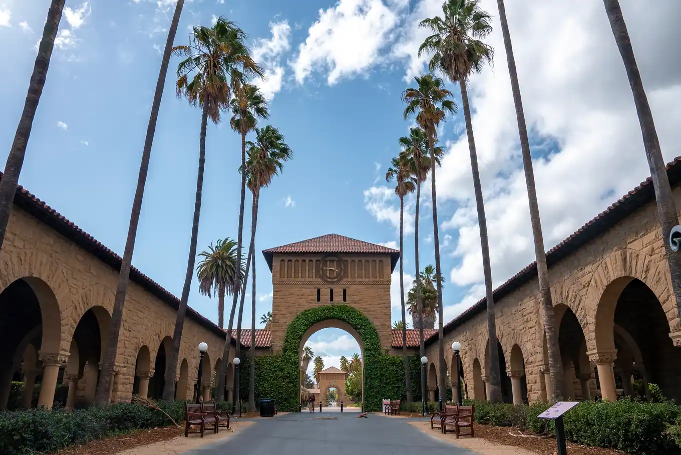 Mission-style arcade and palm trees on a California university campus