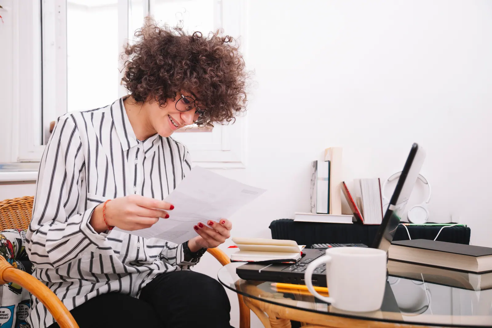 Teenage student at a desk reading through a printed grade report